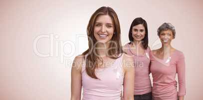 Composite image of smiling women in pink outfits posing for breast cancer awareness