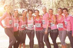 Smiling women running for breast cancer awareness