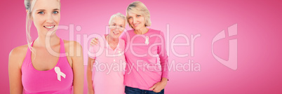 Composite image of portrait of daughters with mother supporting breast cancer awareness