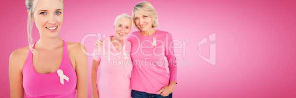 Composite image of portrait of daughters with mother supporting breast cancer awareness