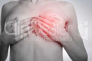 Composite image of midsection of naked woman with pink ribbon covering breast