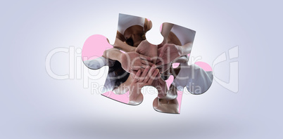 Composite image of women in a circle putting their hands together