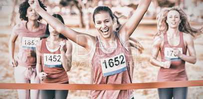 Cheering brunette winning breast cancer marathon