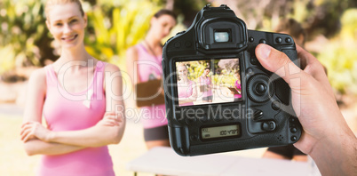 Composite image of cropped hand of photographer holding camera