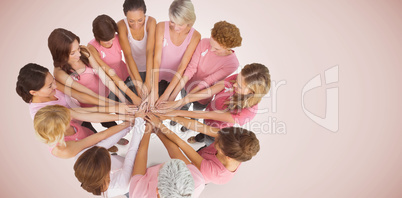Composite image of female friends supporting breast cancer