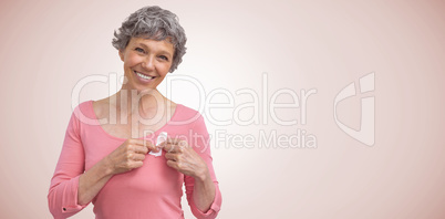 Composite image of woman in pink outfits showing ribbon for breast cancer awareness