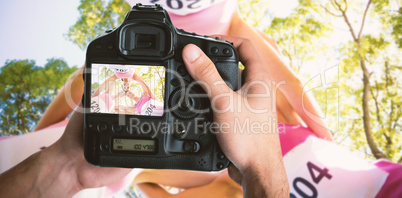 Composite image of cropped image of hands holding camera