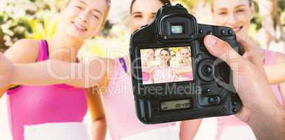 Composite image of cropped hand of photographer holding camera