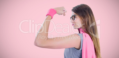 Composite image of woman in superhero costume while flexing muscles