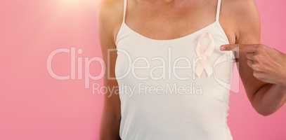 Mid section of young woman pointing at ribbon