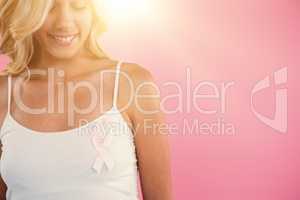 Smiling woman with breast cancer awareness ribbon
