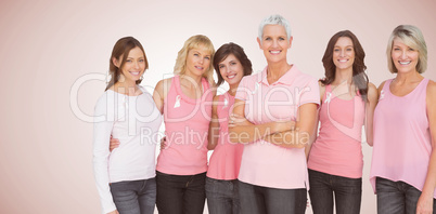 Composite image of portrait of confident women supporting breast cancer awareness