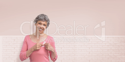 Composite image of woman in pink outfits showing ribbon for breast cancer awareness