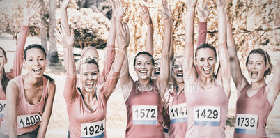 Smiling women running for breast cancer awareness