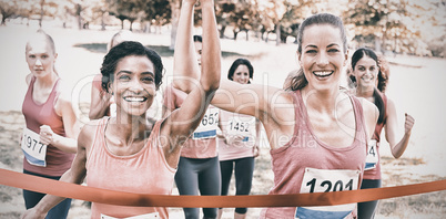 Breast cancer participants crossing finish line at race