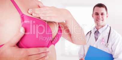Composite image of mid section of woman in pink bra examining breast for cancer awareness