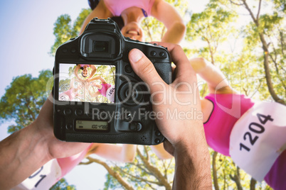 Composite image of cropped image of hands holding camera