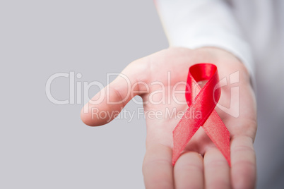 Composite image of midsection of person holding aids awareness ribbon