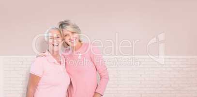 Composite image of portrait of happy daughter with mother supporting breast cancer awareness