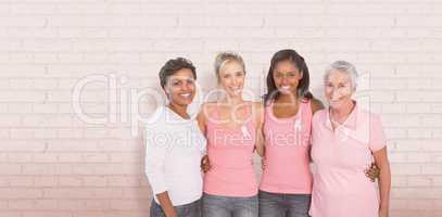 Composite image of portrait of happy women supporting breast cancer social issue