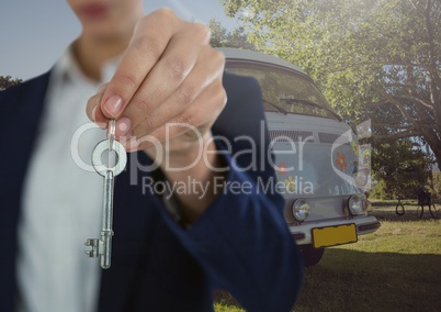 Businesswoman Hand  Holding key in front of camper van