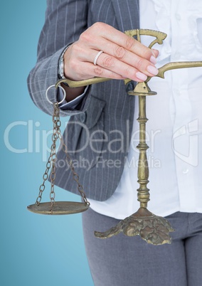 Female judge mid section with scales against blue background