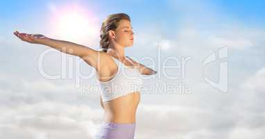 Woman arms outstretched against sunny sky