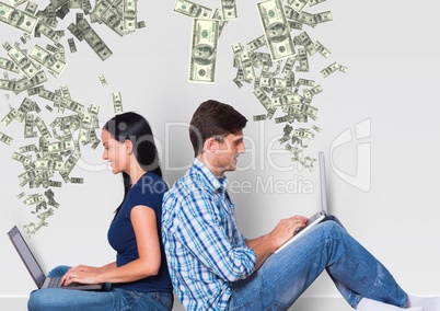 texting money. young couple with laptops. Money coming up from laptops.