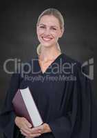 Female judge with book against grey wall