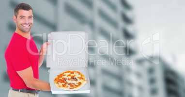 Delivery man with pizza against blurry building