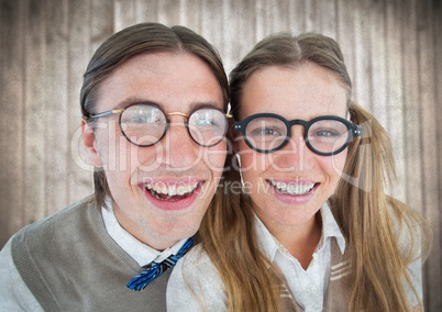 Close up of nerd couple against blurry wood panel with grunge overlay