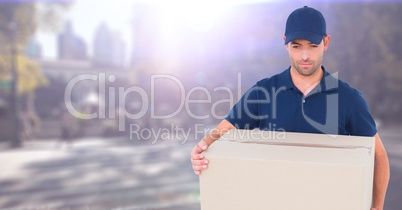 Delivery man with box against blurry street with flare