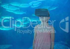 girl with VR glasses on the sea with the fishes