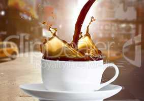 Coffee being poured into white cup against blurry street with flares