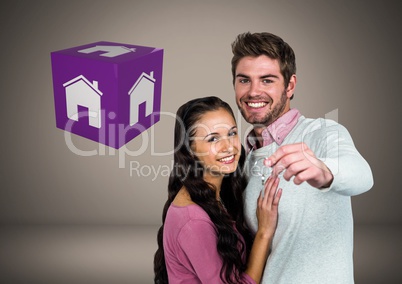 Couple Holding key with house icon cube in front of vignette