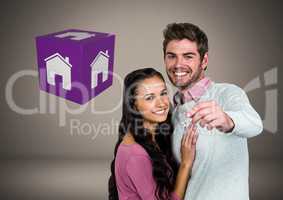 Couple Holding key with house icon cube in front of vignette