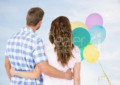 Back of couple looking at balloons