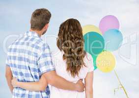 Back of couple looking at balloons