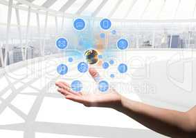 hand with application icons and earth over. Futuristic office