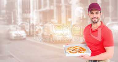 Delivery man  with pizza against blurry street with flare and bokeh