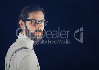 Millennial man looking over shoulder against blue background