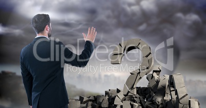 Broken concrete stone with Question symbol and businessman in cityscape