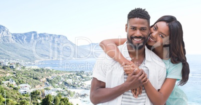 Couple embracing against blurry coastline