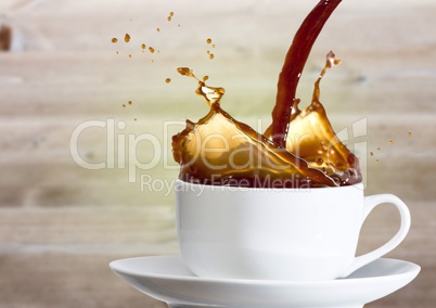 Coffee being poured into white cup against blurry wood panel