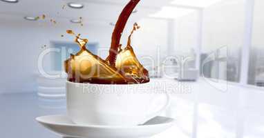 Coffee being poured into cup against blurry white office