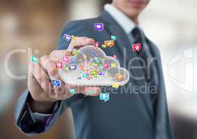 businessman with hand spread of  taking cloud with application icons. Business blurred background