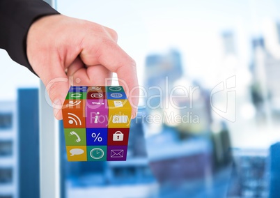 hand taking cube of application icons. Blurred office background