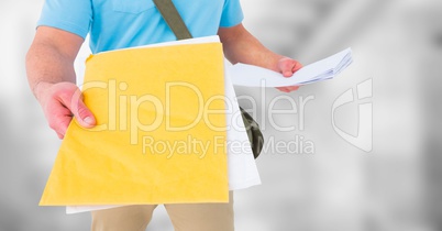 Delivery man mid section with letters against blurry grey stairs