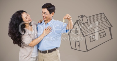 Couple Holding key with house drawing in front of vignette