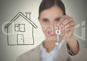 Woman Holding key with house drawing in front of vignette